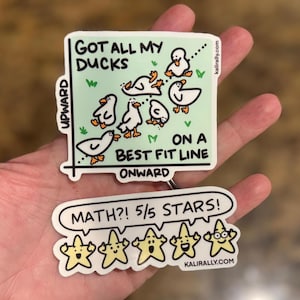 May include: Two die-cut vinyl stickers. The top square sticker features a light green background with white ducks on a graph, text reading GOT ALL MY DUCKS ON A BEST FIT LINE, UPWARD, and ONWARD. The bottom sticker shows five yellow stars with faces, text reading MATH?! 5/5 STARS!