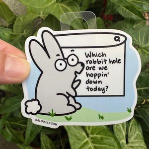 May include: A white rabbit with glasses is looking at a blue and white sign that says "Which rabbit hole are we hoppin' down today?" The sign has a magnifying glass icon in the top right corner.