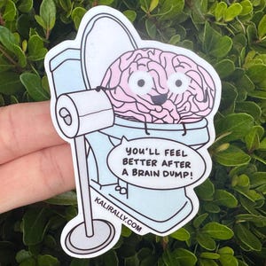 May include: A sticker featuring a cartoon brain sitting in a toilet. The brain is pink with a smiling face. A speech bubble says, "You'll feel better after a brain dump!" The sticker is light blue and white with the website kalirally.com.