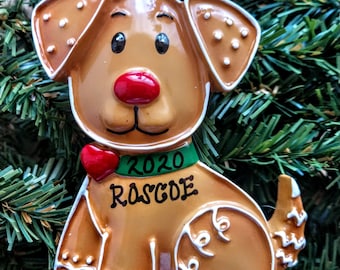 May include: A gingerbread dog Christmas ornament with white icing details, a red heart, and a green collar with the text "2020 RASCOE".
