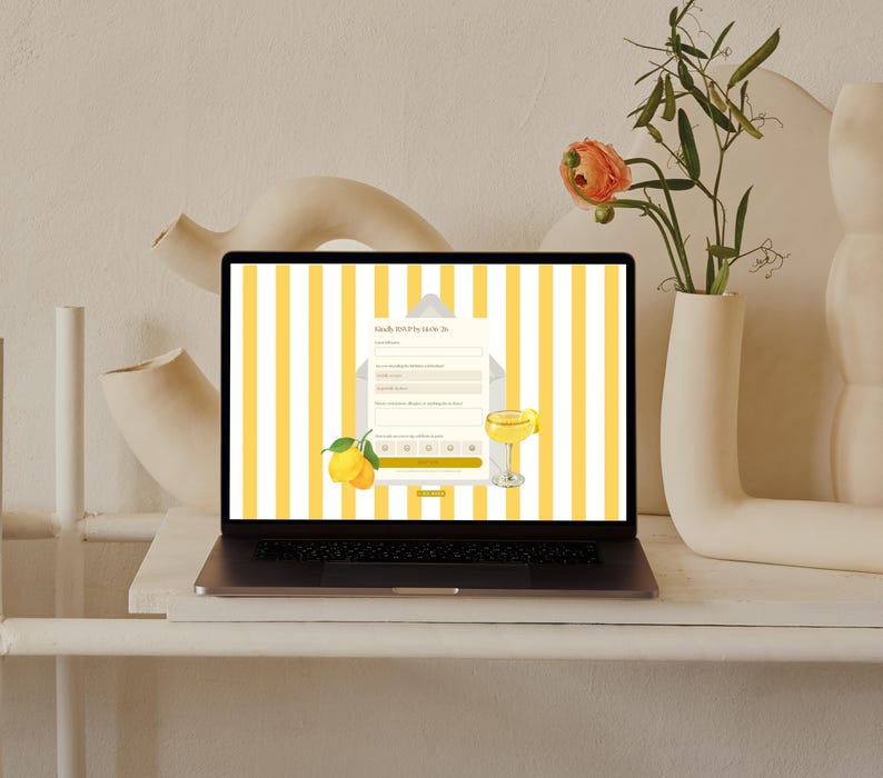 May include: A laptop displaying a webpage with yellow and white stripes, a lemon illustration, and the text "RSVP". The laptop is on a white surface, with a vase of flowers and abstract sculptures in the background.