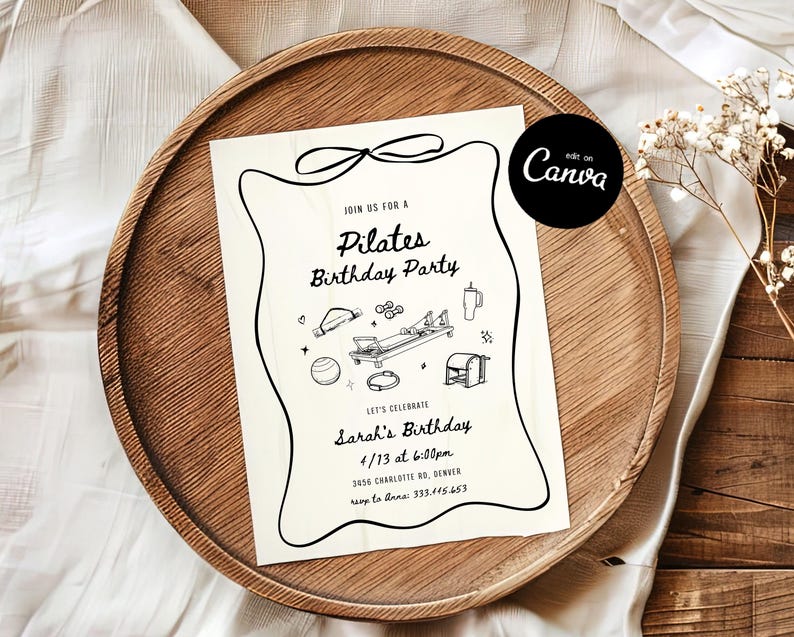 May include: A cream-colored Pilates birthday party invitation with black line art illustrations of exercise equipment and text. The invitation is on a wooden tray with a white cloth and dried flowers.