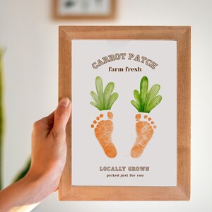May include: A framed print with a baby footprint design. The print says "Carrot Patch farm fresh" and "Locally Grown picked just for you".