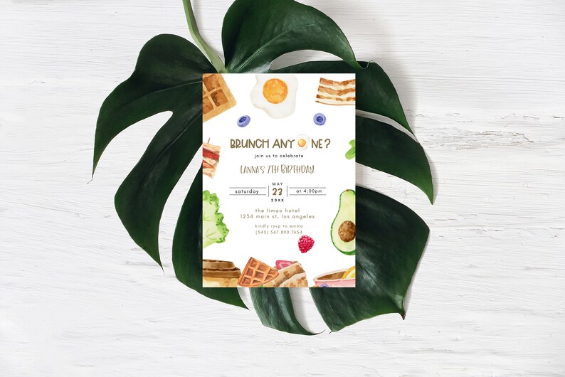 May include: A white invitation card with a watercolour illustration of breakfast foods, including waffles, eggs, bacon, avocado, and fruit. The text on the card reads "BRUNCH ANYONE?" and "Lannes 7th Birthday".