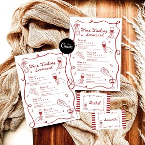 May include: Wine tasting scorecards and name cards with a red and white design. The scorecards have space for wine notes and scores. The name cards are rectangular with red stripes and the names "Rachel" and "Samantha".
