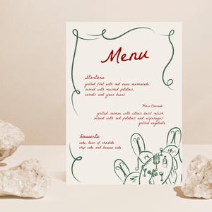 May include: A green and red menu with a hand-drawn illustration of a table setting with people sitting around it. The menu lists "Starters", "Main Course", and "Desserts" with descriptions of each dish.