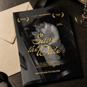 May include: A black and white Save the Date card featuring a couple on stairs with gold text that reads A FILM BY THE MORRISONS, BEST COUPLE OF THE YEAR, BEST LOVE STORY, LILLY REYNOLDS, CHARLIE MORRISON, WE ARE GETTING MARRIED! SEPTEMBER 30, 2026, SAN FRANCISCO, CALIFORNIA, INVITATION TO FOLLOW.