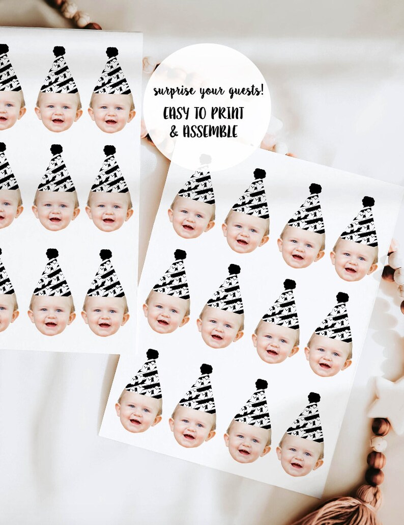 May include: Printable party hat stickers with a black and white pattern and a black pom-pom on top. The stickers feature a baby's face in the center of each hat. The text "surprise your guests! EASY TO PRINT & ASSEMBLE" is printed on the page.