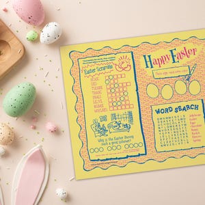 May include: A festive Easter scene featuring speckled eggs in pastel shades, a wooden egg holder, and a yellow activity sheet. The sheet includes an Easter scramble, word search, and a bunny maze. Easter bunny ears are also present.