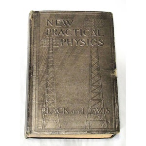 May include: A vintage book titled "New Practical Physics" by Black and Davis. The cover is brown with a gold embossed design of two radio towers.