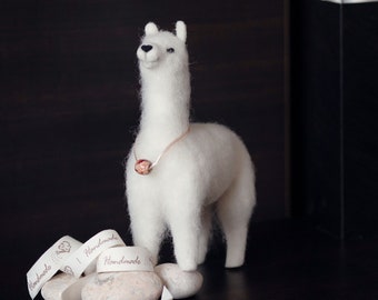 Fluffy white alpaca. Felted sculpture of a lama. Home decoration.