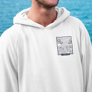 May include: White hooded sweatshirt with a black and white graphic print of waves and palm trees. The graphic includes the text "LA JOLLA, CA".