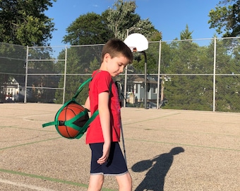 Carry your Basketball, Soccer Ball, or Vollyball in style with the B-BALL SLING over-the-shoulder athletic ball carrier!