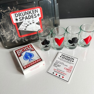 May include: A drinking game set with a deck of standard playing cards, four shot glasses, and a set of rules for a game called "Drunken Spades". The rules include the number of shots to take for different infractions during the game.