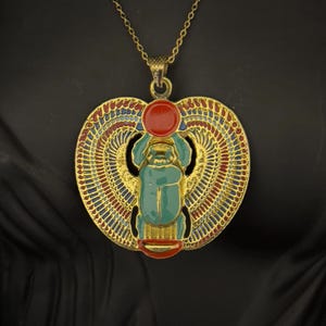 Turquoise Winged Scarab Necklace with Gold-Tone Finish – Egyptian Revival Jewelry Featuring Sun Disc and Detailed Enamel Wings Made in Egypt
