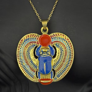 Blue Enamel Winged Scarab Necklace with Gold-Tone Finish – Egyptian Revival Jewelry with Sun Disc Symbol and Detailed Wings Made in Egypt