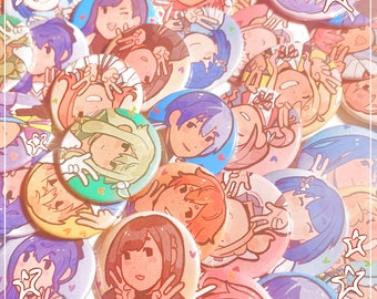 May include: A collection of colorful round buttons featuring anime-style character illustrations. The buttons have various background colors, including blue, pink, and green, with images of smiling faces and peace signs. The text "Shiroplushie shop!" is visible.