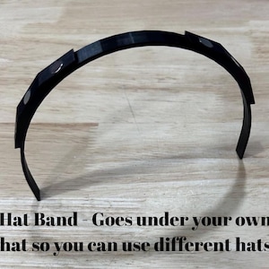 May include: Black plastic hat band with magnetic closures. Hat Band - Goes under your own hat so you can use different hats.