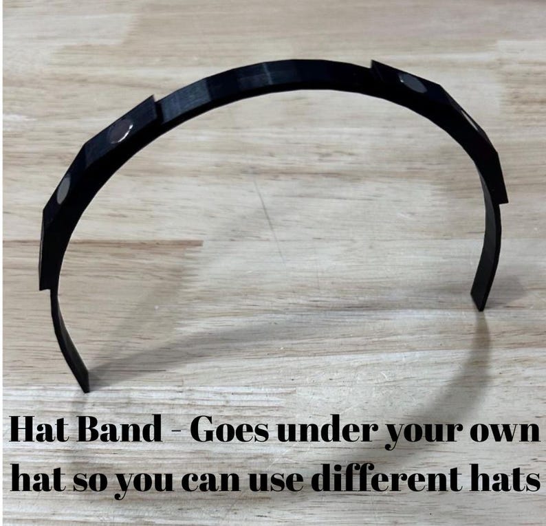 May include: Black plastic hat band with magnetic closures. Hat Band - Goes under your own hat so you can use different hats.