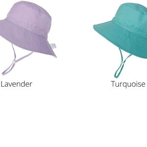 May include: Two sun hats, one lavender and one turquoise, with a wide brim and a chin strap.