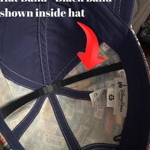 May include: A blue baseball cap with a black band inside. The cap has a colorful pattern on the outside with the text "Disney Parks" and "602 2401800" visible.