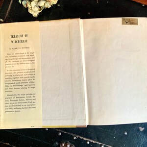 Puede incluir: Un libro vintage titulado "Treasury of Witchcraft" de Harry E. Wedeck. La portada del libro es blanca con texto negro y una columna vertebral amarilla. La contraportada tiene una descripci&oacute;n del contenido del libro, incluida informaci&oacute;n sobre la historia de la brujer&iacute;a y sus pr&aacute;cticas.
