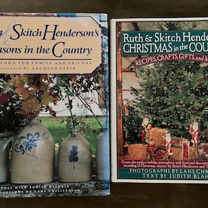 May include: Two cookbooks with a Christmas theme. The book on the left is titled "Ruth & Skitch Henderson's Seasons in the Country: Good Food for Family and Friends". The book on the right is titled "Ruth & Skitch Henderson's Christmas in the Country: Recipes, Crafts, Gifts, and Music".