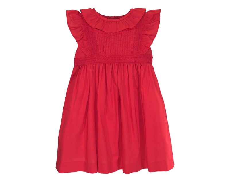 May include: A red sleeveless dress with a ruffled collar and a gathered skirt.