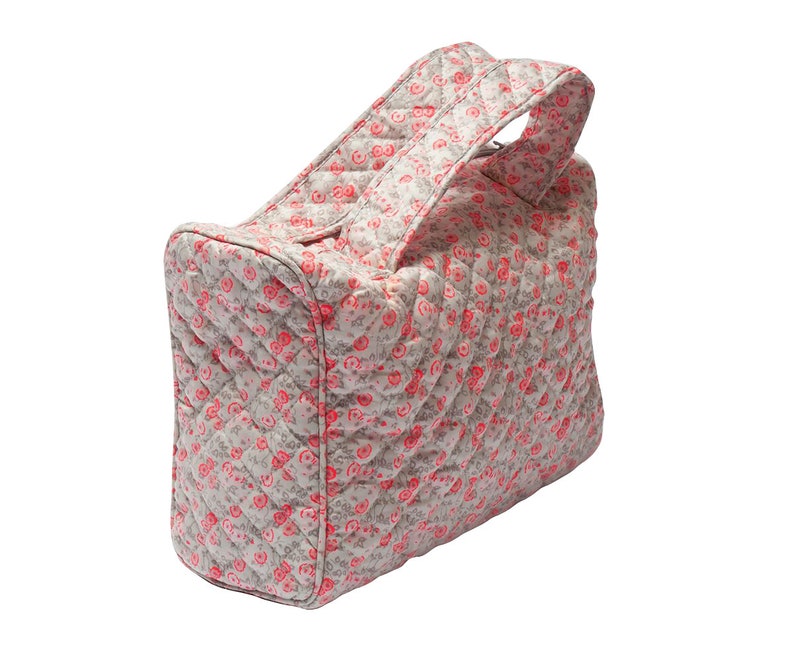 K&ouml;nnte beinhalten: Eine gesteppte Kosmetiktasche mit floralem Muster in Rosa und Wei&szlig; und einem oberen Tragegriff.