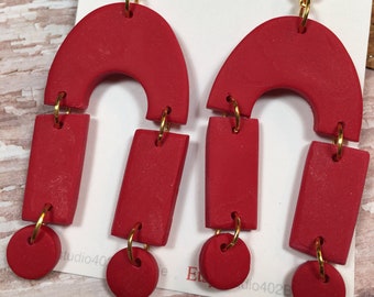 Handmade, Polymer Clay, Statement earrings,  deep red with gold finishings,  half circles, and circles, in a dangle.