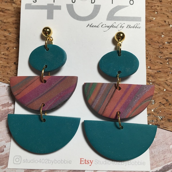 Handmade, polymer Clay, chandelier, statement earrings, teal with fuchsia and orange swirls, ovals , semi-circle, dangle, in gold.