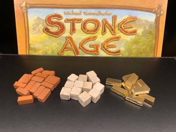 Premium Stone Age resources (wood, bricks, stone and gold), custom board game token upgrades