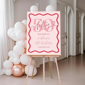 May include: Pink and red welcome sign with the text "fifty" and a heart. The sign also says "Welcome to Kathryn's 50th Birthday 10 November, 20XX".