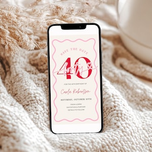 May include: A smartphone displays a pink and cream-colored invitation with the text "Save the Date" and "40 & Forty" in a script font. The invitation is for Carla Robertson's 40th birthday, scheduled for Saturday, October 10th.