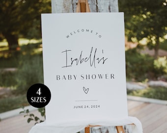 May include: White welcome sign with black text that reads "Welcome to Isabella's Baby Shower" with a heart symbol and the date "June 24, 2024".