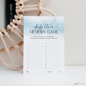 May include: A baby item memory game card with a watercolor blue background. The card includes the text "baby item MEMORY GAME" and prompts to list items to remember. The score is out of 20.