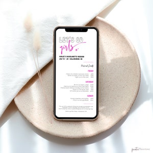 May include: A pink and white digital phone screen with the text "Let's Go Girls" and a schedule for a bachelorette weekend in Collingwood, Ontario, Canada. The schedule includes events like brunch, dinner, and a night out on the town. The text "Weekend Events" is in pink.