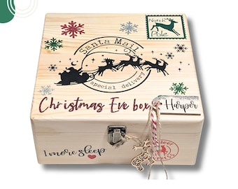 May include: A square wooden box with a metal latch, featuring a Santa Mail graphic with a sleigh and reindeer, snowflake accents, and the text Christmas Eve box, 1 more sleep, and North Pole. A wooden tag with the name Harper is attached.