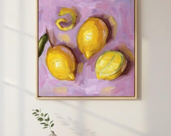 Puede incluir: Una pintura al óleo en un marco de madera cuadrado que representa dos limones amarillos enteros, una rodaja de limón y una cáscara de limón en espiral. La fruta está pintada con pinceladas visibles sobre un fondo texturizado de color violeta claro.