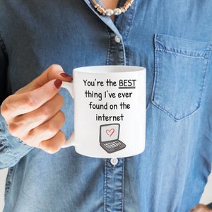 May include: White ceramic mug with a black and grey laptop illustration and the text "You're the BEST thing I've ever found on the internet" in black.