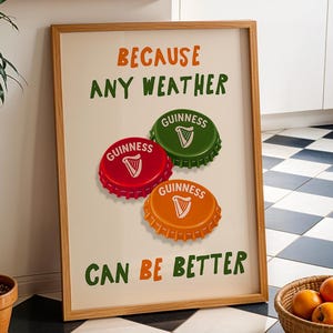 May include: A framed print with the text "BECAUSE ANY WEATHER CAN BE BETTER" and three Guinness bottle caps in red, green, and orange. A potted plant and a basket of oranges are in the foreground. The background features a black and white checkered floor.