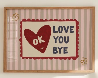 May include: A framed art print with a pink and gray striped background. The artwork features a red heart with the word "ok" inside, and the words "LOVE YOU BYE" in navy blue. Decorative floral accents are in the corners.