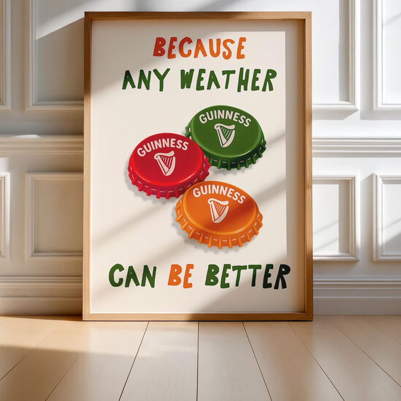 May include: A framed print featuring the text "BECAUSE ANY WEATHER CAN BE BETTER" in orange and green. The image includes three Guinness bottle caps in red, green, and orange, each with the Guinness logo.