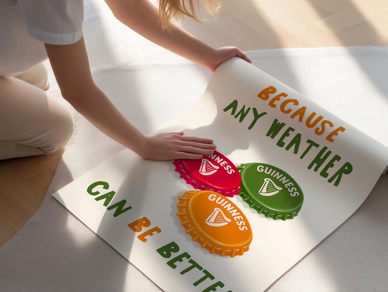 May include: A poster with the text "BECAUSE ANY WEATHER CAN BE BETTER" in green and orange. The poster features three bottle cap designs in red, green, and orange, each with the Guinness logo.