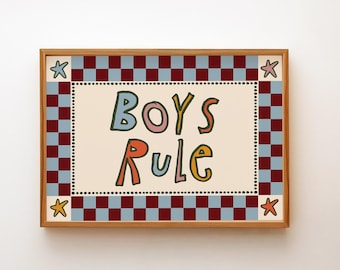 May include: A framed art print with the words "BOYS RULE" in colorful, playful lettering. The artwork features a cream-colored background with a dotted border, surrounded by a red and blue checkered pattern and star accents.
