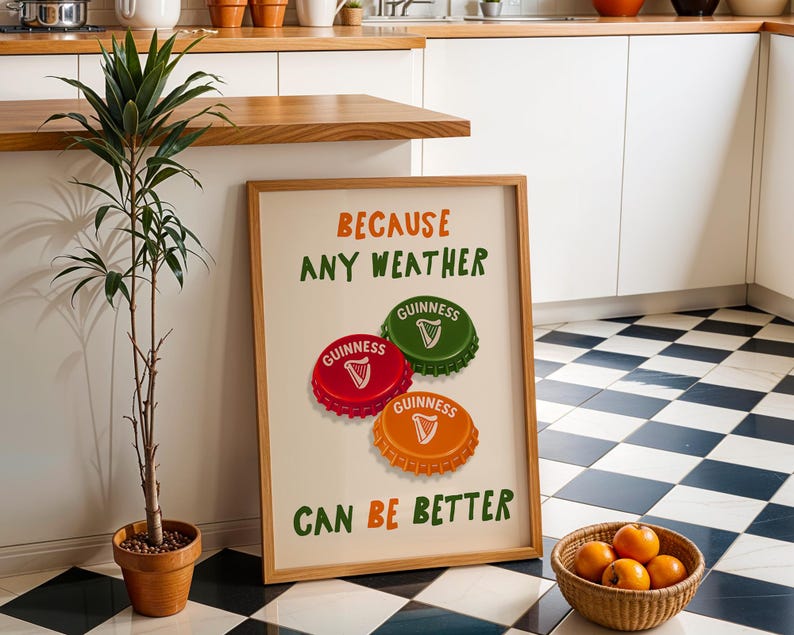 May include: A framed print with the text "BECAUSE ANY WEATHER CAN BE BETTER" and three Guinness bottle caps in red, green, and orange. A potted plant and a basket of oranges are in the foreground. The background features a black and white checkered floor.