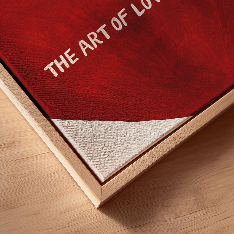May include: A framed canvas print with the text "THE ART OF LOVE" in white against a red background. The bottom portion of the canvas is white. The frame is made of light-colored wood.
