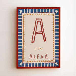 May include: A rectangular wall art print featuring a cream-colored center with a large red letter A, the text 'is for', and the name 'ALEXA' in red. The design is bordered by a yellow scalloped line and a blue and white striped frame with red edges.