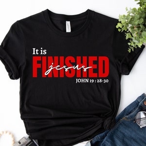 May include: Black t-shirt with the text "It is FINISHED jesus JOHN 19:28-30" in white and red lettering.