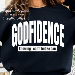 May include: Black sweatshirt with white text that reads "GODFIDENCE knowing I can't but He can".